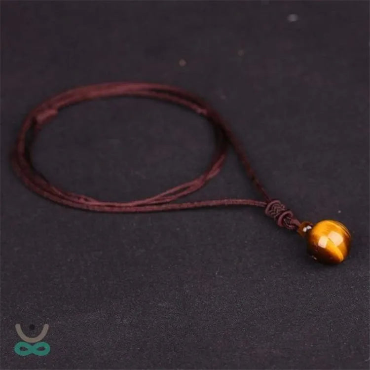 Colgante de Ojo de Tigre con Cordón Trenzado – Protección, Confianza y Equilibrio