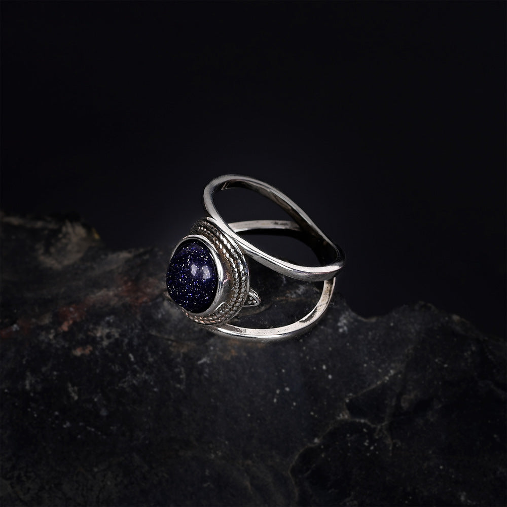 Anillo de arenisca azul ovalada chapado en cobre, concentración brillante y estilo cósmico